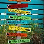 Vibrant signpost with distances to famous destinations, perfect for travel themes.